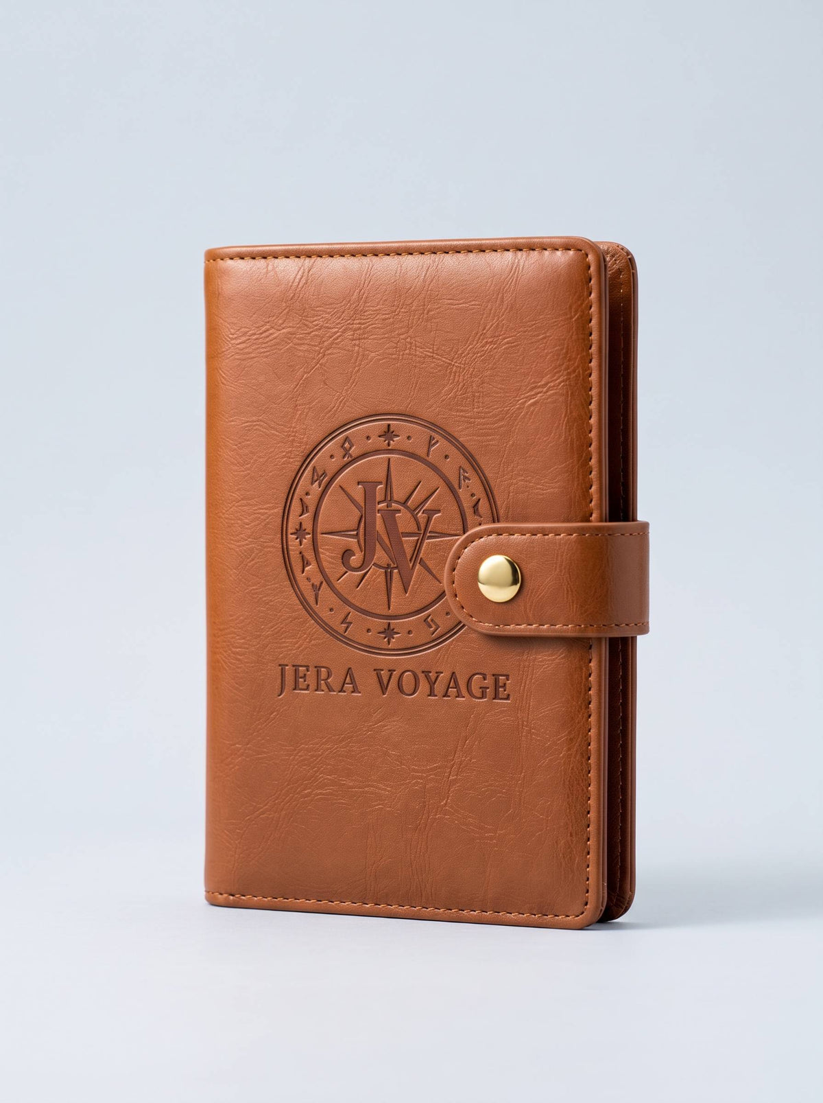 The Voyager RFID Passport Wallet in cognac, front view with the debossed Jera Voyage seal