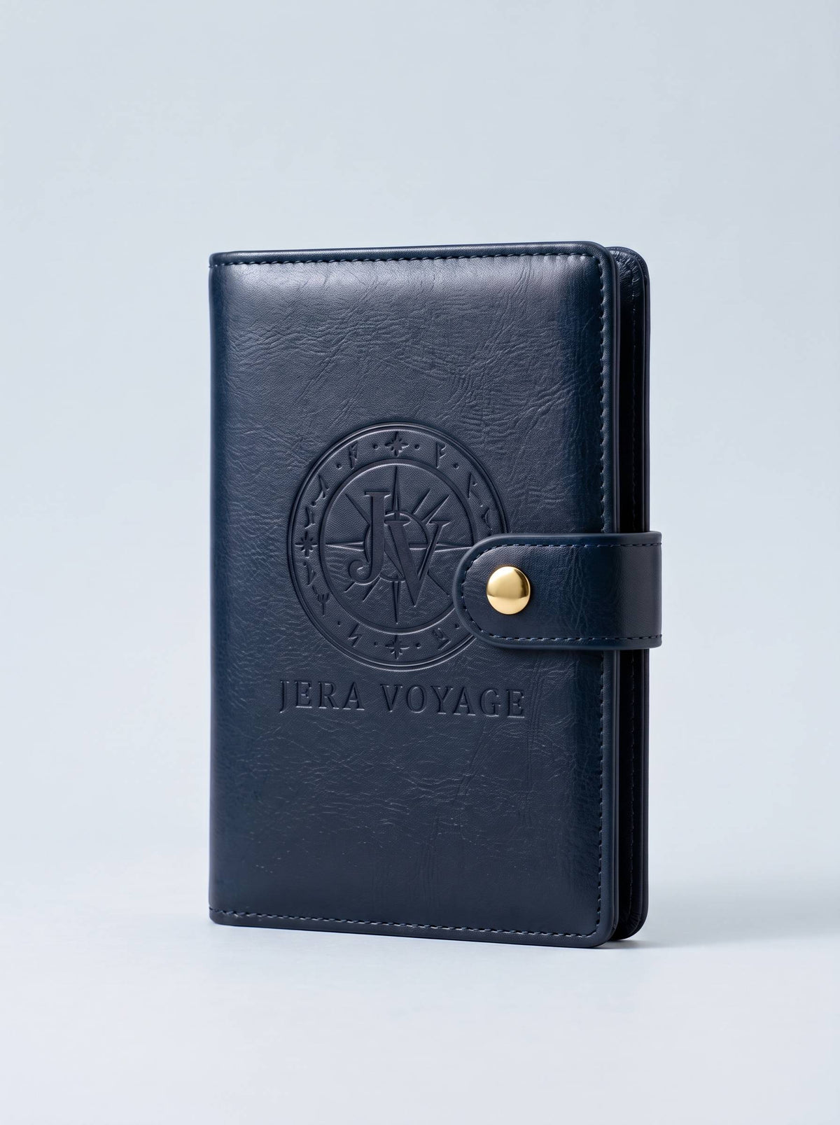 The Voyager RFID Passport Wallet in navy, front view with the debossed Jera Voyage seal