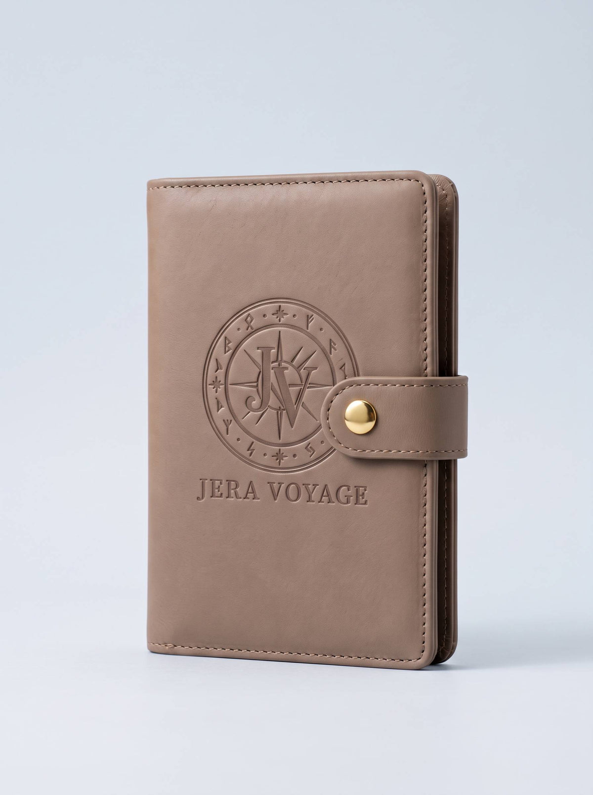 The Voyager RFID Passport Wallet in taupe, front view with the debossed Jera Voyage seal
